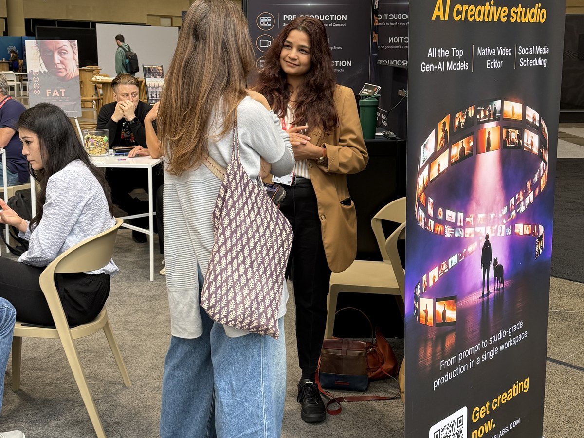 Visitors talking in front of the Moonlite Labs banner at the booth